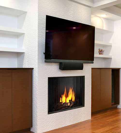 Tarin Cabinets surrounding TV and Fireplace Chestnut Stain